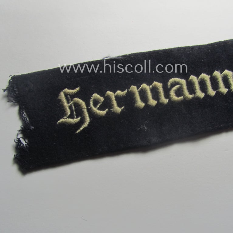 Truly used and typical 'smooth-woolen'-based, EM- (ie. NCO-) pattern WH (Luftwaffe) cuff-title (ie. 'Ärmelstreifen') entitled: 'Hermann Göring' that comes in a period-shortened and worn condition