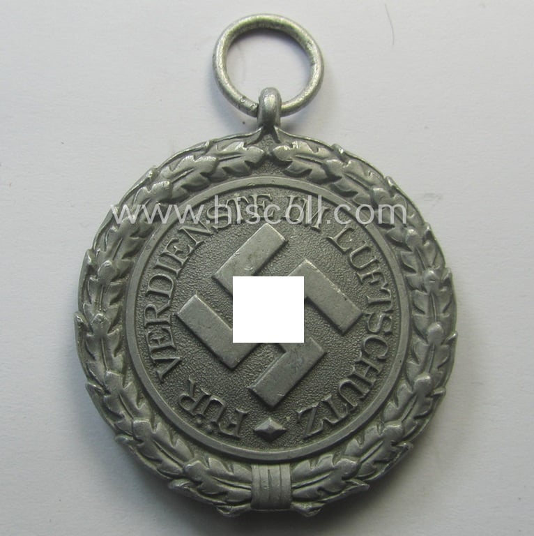 'Luftschutz-Ehrenzeichen 2. Stufe' being a maker- (ie. '10'-) marked example, as executed in (light-weight) aluminium-based metal and that came together with its period ribbon (ie. 'Bandabschnitt')