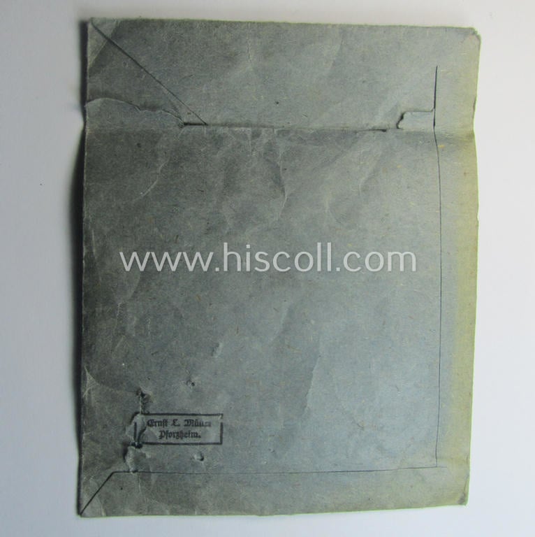 'Zellstoff'-based medal-pouch entitled: 'Infanterie-Sturmabzeichen - Silber' (or: silver-class infantry assault-badge ie. IAB) as executed in typical: 'Zellstoff'-based paper as was intended to store an IAB by the maker: 'Ernst L. Müller'
