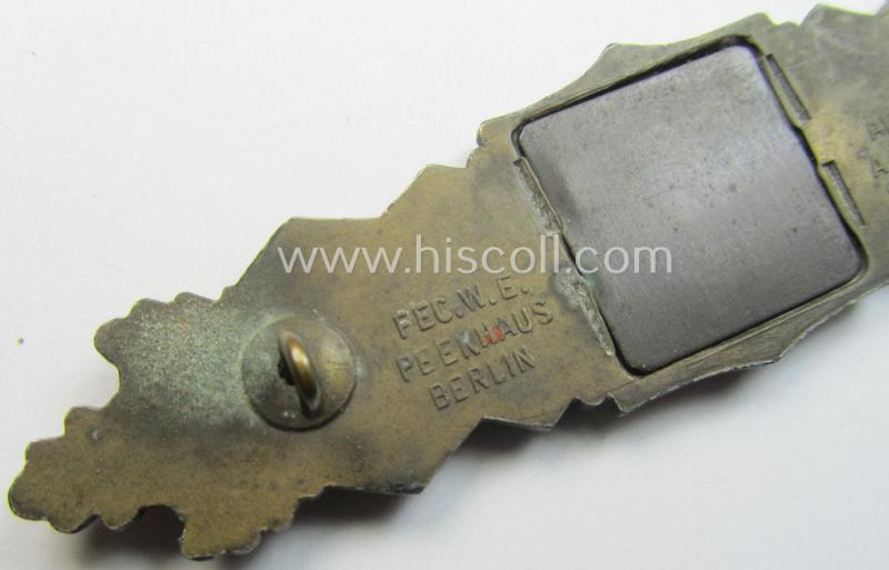 'Nahkampfspange in Bronze' (or: bronze-class close-combat clasp ie. CCC) being a maker- (ie. 'A.G.M.u.K.'-) marked- and/or minimal converse-shaped specimen having its period-attached (steel-based) 'back-plate' in place