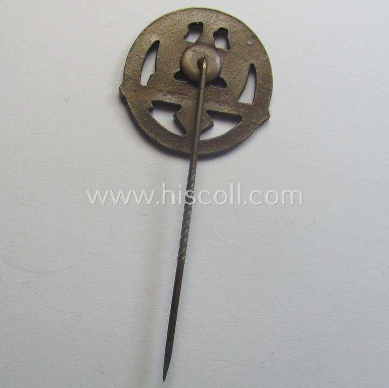 Golden-bronze-toned, so-called: 'Nationalsozialistischer Soldatenring' (ie. 'NSR') membership-badge (or: 'Mitgliedsabzeichen') being a maker- (ie. 'F. Petzl'-) marked example that comes mounted onto its long-sized pin