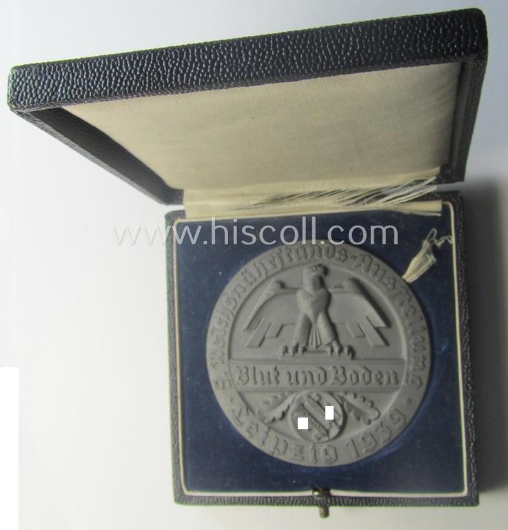 Greyish-silver-toned, 'Reichsnährstand'- (ie. 'RNSt.'-) related, commemorative-award-plaque entitled: 'Reichsnährstands-Austellung - Blut und Boden - Leipzig 1939 - erhitzte Milch' and that comes stored in its period etui
