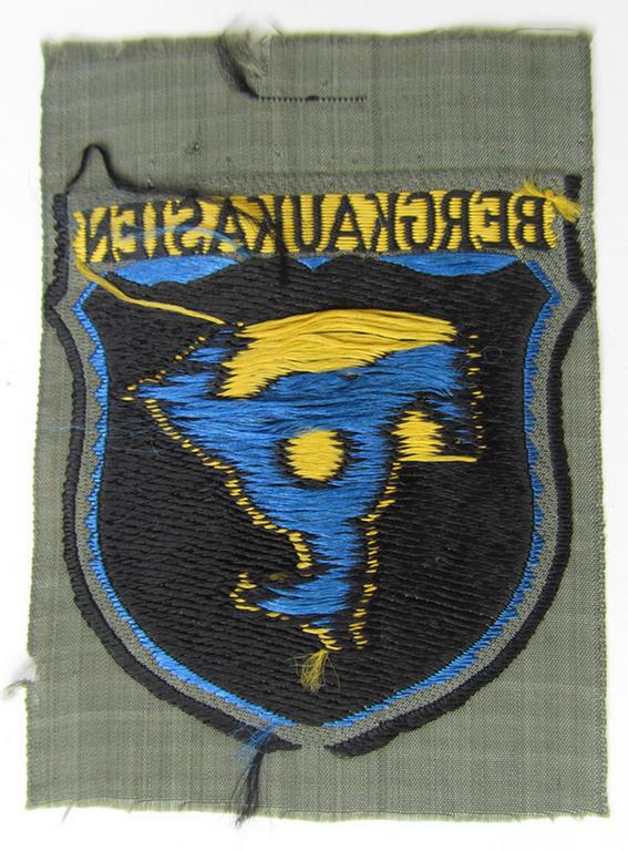 Attractive, 'BeVo'-type armshield (of the second pattern-) entitled: 'Bergkaukasien', being a piece as intended for a volunteer who served within the 'Deutsche Wehrmacht' ie. within the 'Berg- o. Nord-Kaukasisches Legion'