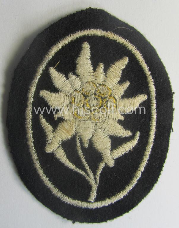 Waffen-SS-pattern, black-coloured sleeve-insignia (ie. 'Ärmelabzeichen') depicting an: 'Edelweiss'-flower as used by the various 'Gebirgsjäger'- (ie. mountain-troops-) related divisional-staff