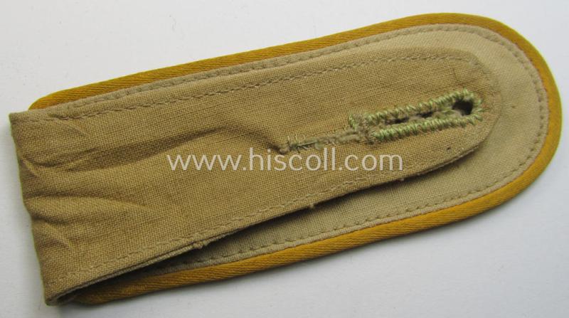 Single, WH (Luftwaffe) tropical-issued, EM-type-shoulderstrap as executed in beige-coloured linnen (as was specifically intended for usage on the tropical-shirts ie. tunics) as was intended for a: 'Soldat der Flieger- o. Fallschirmjäger-Truppen'