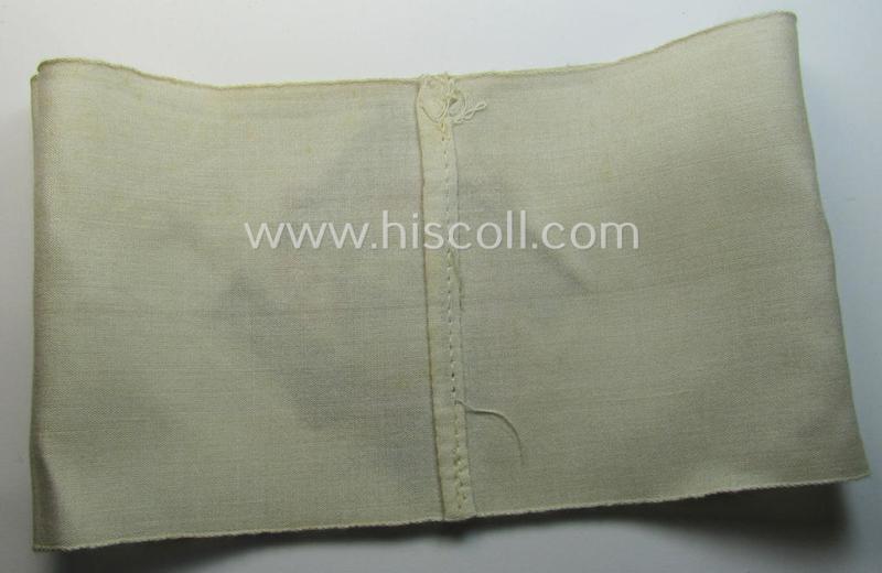 Attractive, beige-white-coloured and typical linnen-based so-called: TeNo (ie.: 'Technische Nothilfe') 'Amtsträger'-armband depicting the typical 'TeNo'-logo (with TN-lettering) and that comes in a just minimally used- ie. worn, condition