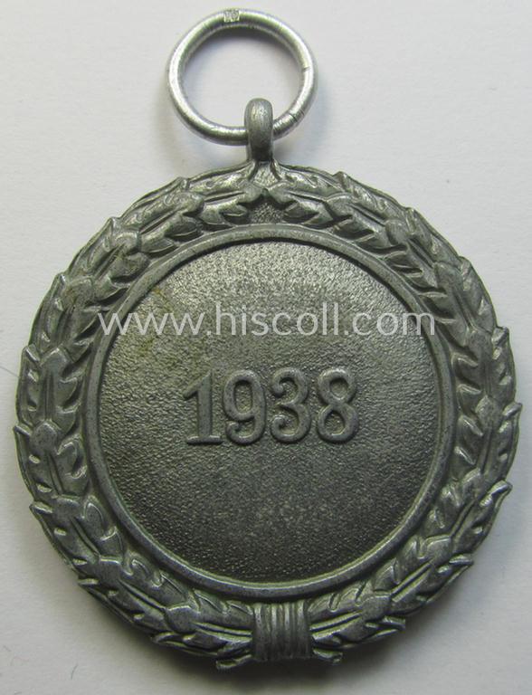 'Luftschutz-Ehrenzeichen 2. Stufe' being a maker- (ie. '10'-) marked example, as executed in (heavy) zinc-based metal (ie. 'Feinzink') and that came together with its period ribbon (ie. 'Bandabschnitt')