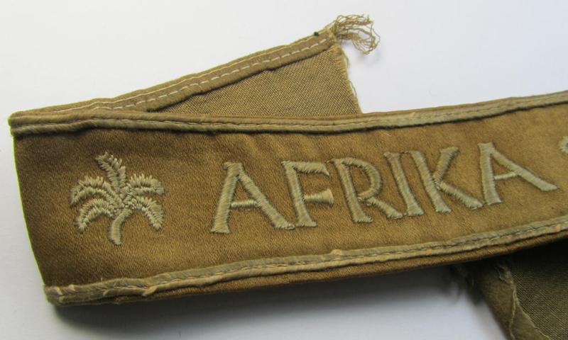 Attractive, WH (LW o. Heeres) cuff-title (ie. 'Ärmelstreifen') entitled: 'Afrika' (being a period-shortened- and woolen-based example that comes in a clearly issued- and/or worn condition)