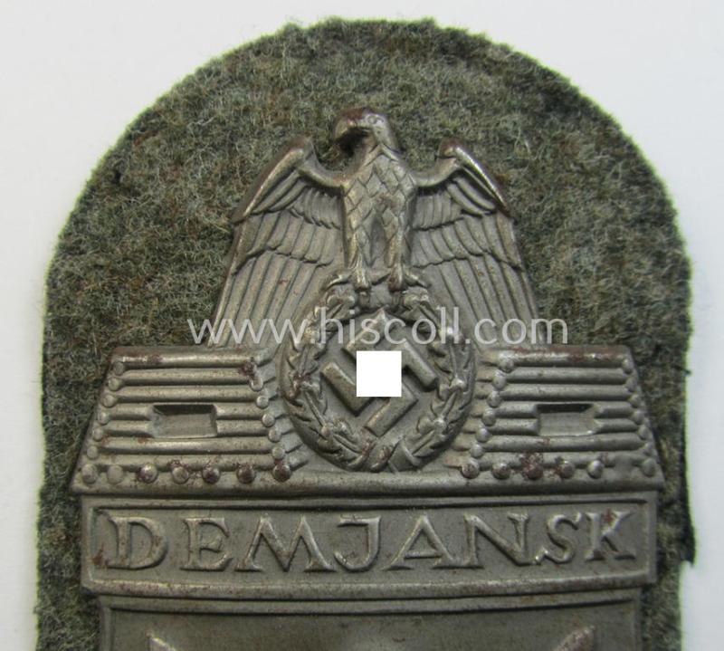 Superb example of a - fairly scarcely encountered! - WH (Heeres ie. Waffen-SS) 'Demjansk'-campaign-shield as executed in typical magnetic metal (ie. so-called: 'Eisenblech') and that comes in an overall very nice- ie. fully untouched, condition