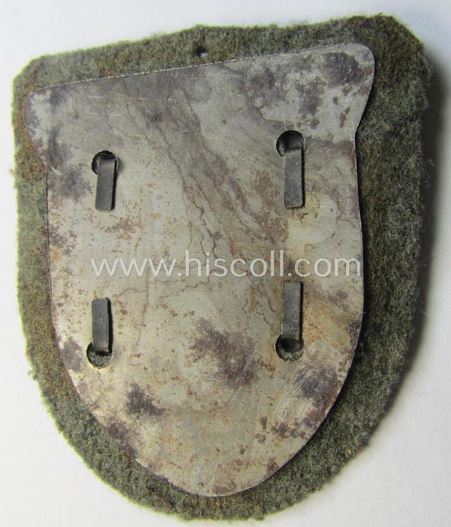 Attractive - just minimally used and actually scarcely encountered! - WH (Heeres ie. Waffen-SS) 'Kuban'-campaign-shield that comes mounted onto its original field-grey-coloured- and/or woolen-based 'backing'