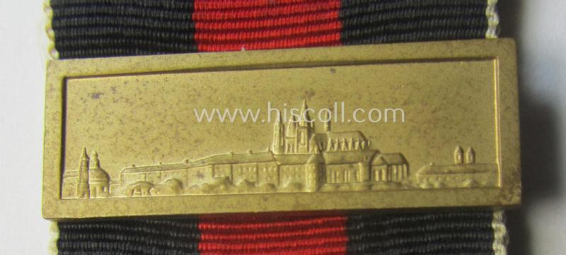 WH Czech-occupation- (ie. 'Anschluss'-) medal: '1. Oktober 1938' being a neat (albeit minimally tarnished) example that comes mounted onto its period ribbon and that shows a firmly (and period!) attached 'Prager Burg-Spange'