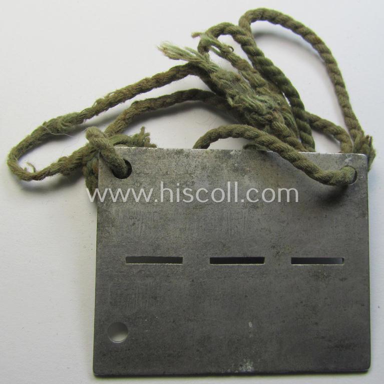 Unusually found, zinc-based WH (Heeres) 'Frontstalag'- (ie. prisoner-related-) ID-disc bearing the clearly stamped camp-designation that reads: 'Frontstalag 183' and that comes still mounted onto its (period-attached) cord as issued- and/or worn