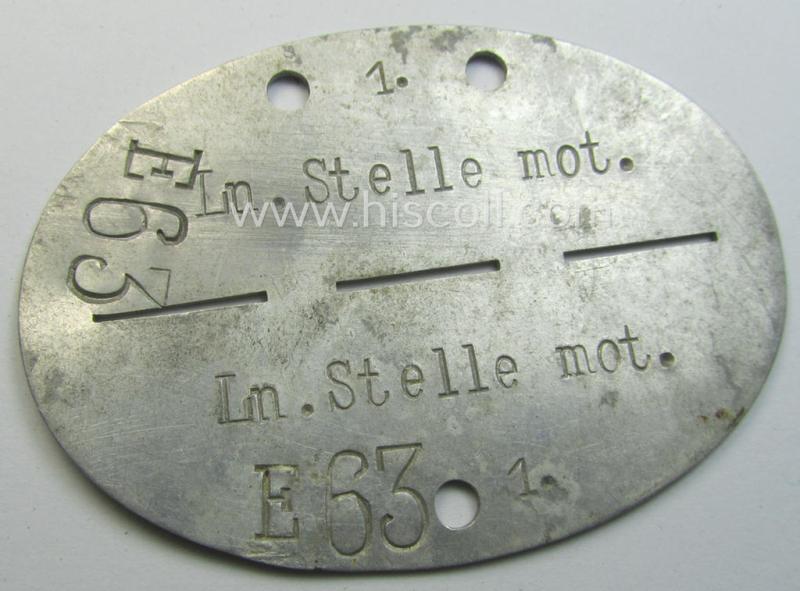 Aluminium-based WH (Luftwaffe) ie. 'Luftnachrichten'-related ID-disc (ie. 'Erkennungsmarke') bearing the stamped unit-designation that reads: 'Ln.Stelle mot - E63' and that comes stored in its period (linnen-based) pouch