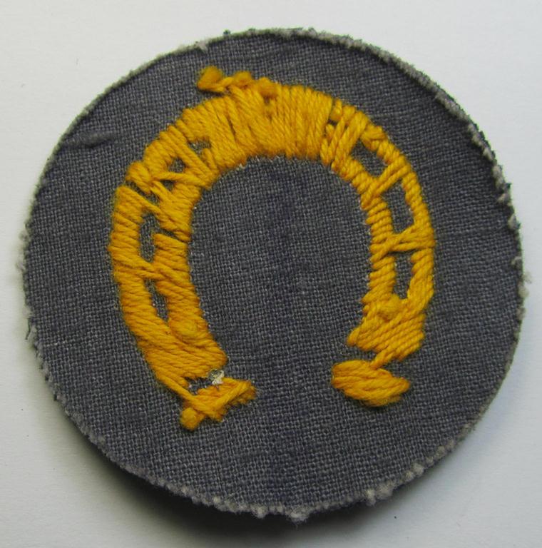 Attractive, WH (Heeres) so-called: trade- and/or special career arm-insignia as was intended for a: 'Hufbeschlagmeister' (or: farrier) being a neatly hand-embroidered 'variant' as executed on darker-green-coloured wool