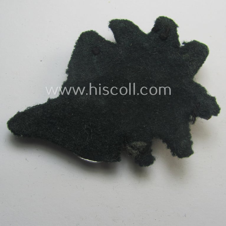 Truly worn, WH (Heeres) (bright) silverish- (ie. golden-) coloured, aluminium-based so-called: 'M43'-pattern 'Edelweiss'-cap-badge (ie. 'Mützenabzeichen') that came mounted onto its piece of darker-green-toned wool