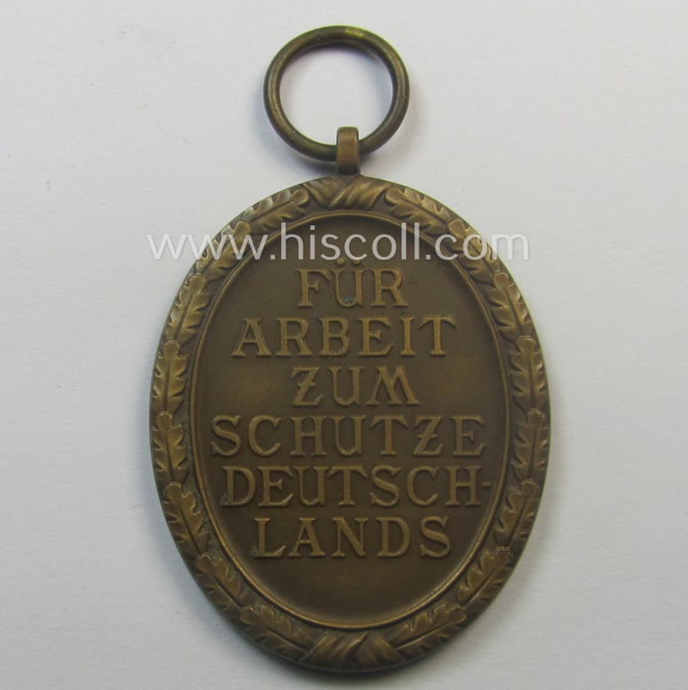 Medal-set: 'Deutsches Schutzwall Ehrenzeichen' (aka: 'Westwall'-medal) being a (typical) non-maker-marked- and/or: typical 'Buntmetall'-based specimen that comes packed in its original pouch of issue by the: 'Friedrich Orth'-company
