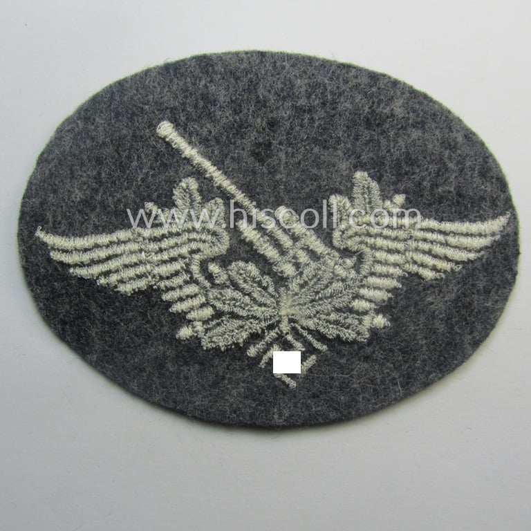 Machine-embroidered WH (Luftwaffe) trade- ie. special-career-patch as was intended for: 'Flak-Artillerie'-staffmembers and that comes in a probably issued but never worn- (ie. 'virtually mint'-), condition
