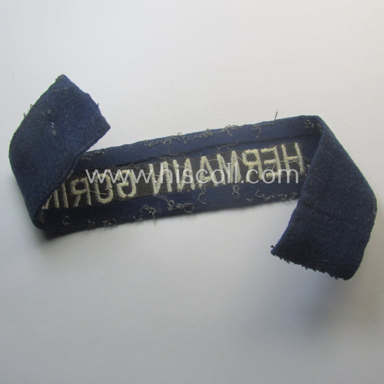 Truly used and typical 'smooth-woolen'-based, EM- (ie. NCO-) pattern WH (Luftwaffe) cuff-title (ie. 'Ärmelstreifen') entitled: 'Hermann Göring' that comes in a period-shortened and worn condition