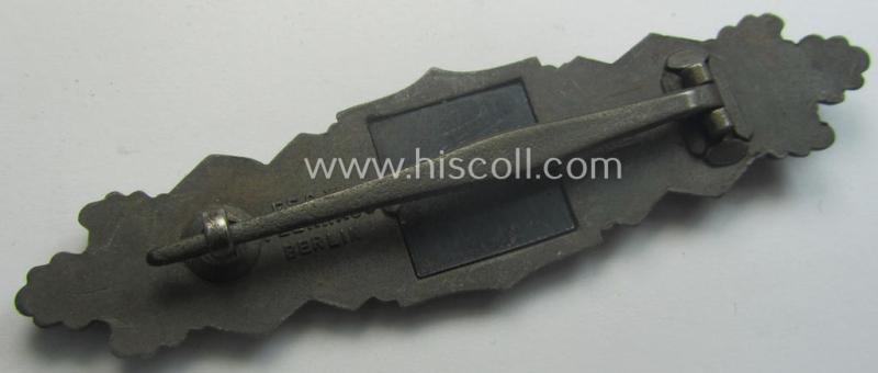 'Nahkampfspange in Bronze' (or: bronze-class close-combat clasp ie. CCC) being a neatly maker-marked- and/or minimally converse-shaped specimen as was produced by the: 'JFS'- (ie. 'Joseph Feix u. Söhne'-) company