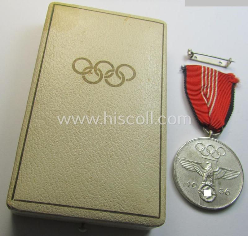 Superb, 'Deutsche Olympia-Erinnerungsmedaille 1936' being a non-maker-marked example that comes mounted onto its original ribbon (ie. 'Bandabschnitt') and that comes stored in its typical, beige-white-coloured etui as issued and stored for decade...