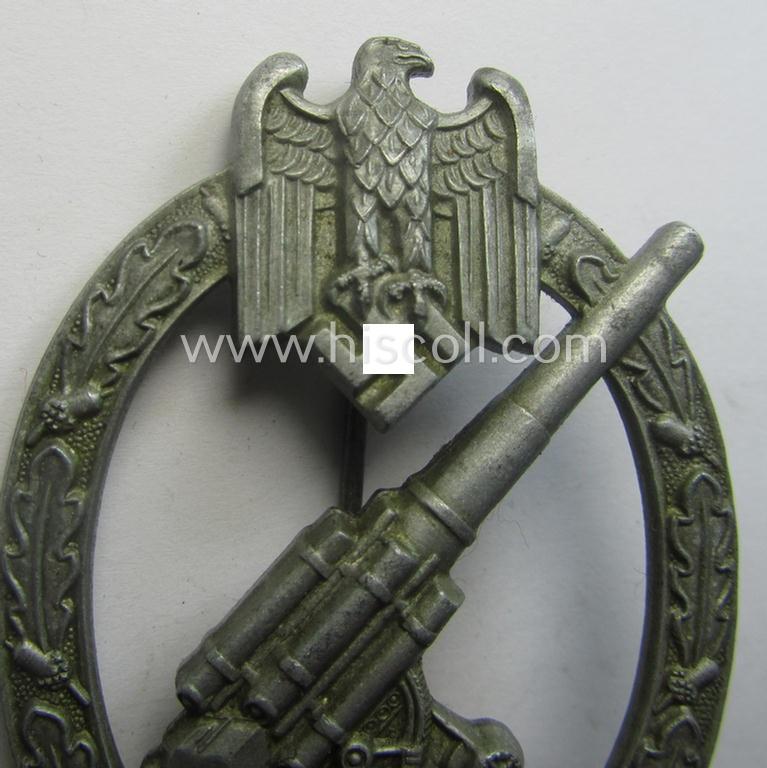 'Heeres-Flakkampf-Abzeichen' being a non-maker-marked- and/or zinc- (ie. 'Feinzink'-) based specimen of the so-called: 'pillow-crimped'-pattern (as was produced by a to date still unidentified maker)