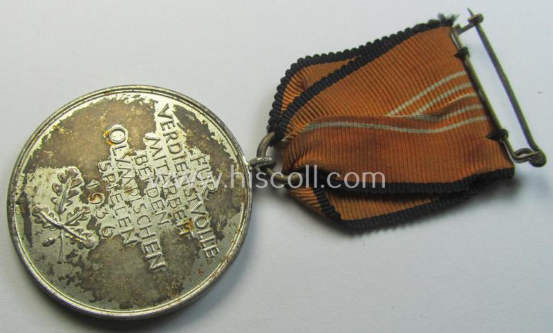 Atractive example of a: 'Deutsche Olympia-Erinnerungsmedaille 1936' being a non-maker-marked example that comes mounted onto its original (orange-red-coloured ribbon (ie. 'Bandabschnitt') as issued