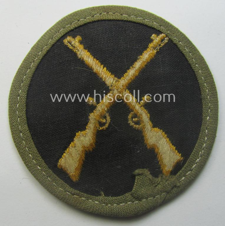 WH (Heeres) 'tropical'-issued, trade- and/or special-career insignia (ie. machine-embroidered 'Laufbahn- o. Tätigkeitsabzeichen') as was intended for an army: 'Waffenmeister' (or: weapon-equipment NCO)