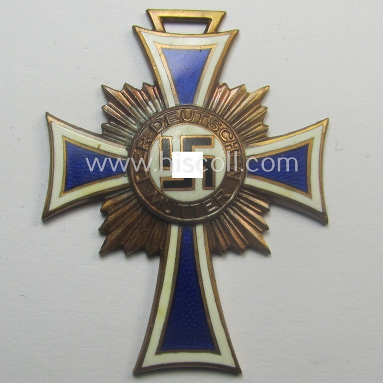 'Ehrenkreuz der deutschen Mutter - dritte Stufe' (or: bronze-class mothers'-cross) that came together with its long-sized ribbon and that came stored in its period pouch by the maker: 'G. Danner - Mühlhausen/Th.'