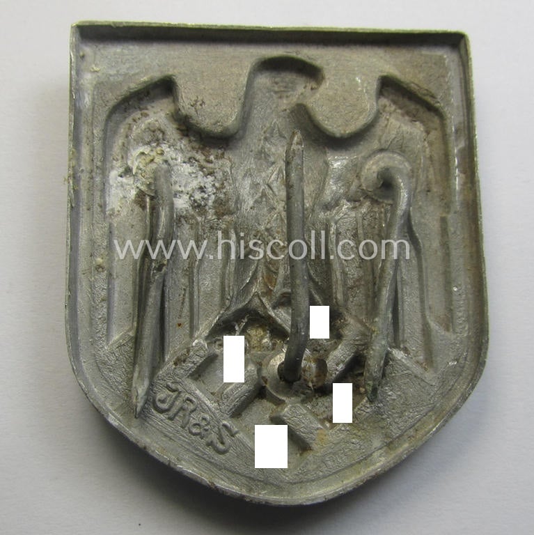 WH (Heeres) tropical- (ie. 'DAK'- or: 'Deutsches Afrikakorps'-) related- and/or aluminium-based, eagle-'pith-helmet'-shield being a maker- (ie. 'JR&S'-) marked example that comes in a clearly used-, condition