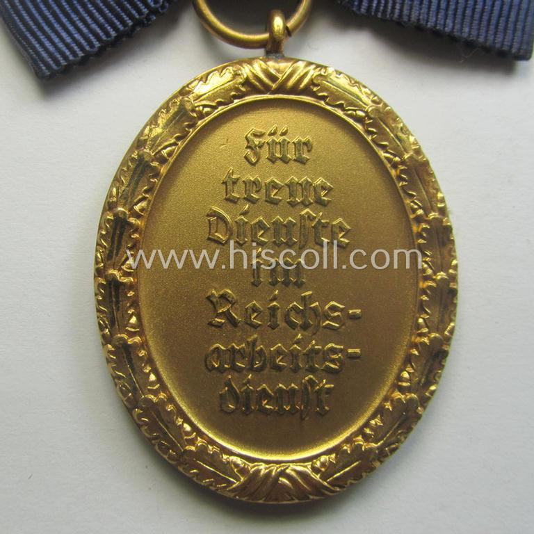 Superb - and very rarely encountered! - example of a: 'RAD der weiblichen Jugend' (or: RADwJ) so-called: 'Dienstauszeichnung 1. Stufe in Gold' that comes mounted onto its period-attached ('bow-tie'-shaped!) ribbon (ie. 'Bandabschnitt')