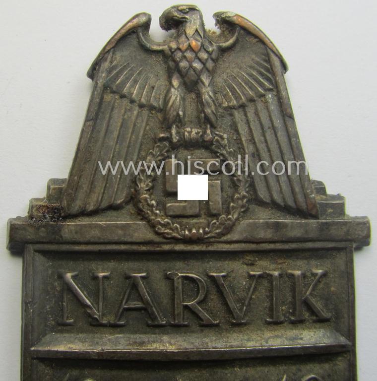 Truly worn - but regrettably incomplete but nevertheless rarely encountered! - WH (Heeres) 'Narvik'-campaign-shield as executed in silver-toned 'Buntmetall' (ie. Cupal) and that comes in a clearly issued- (and once tunic-attached-), condition