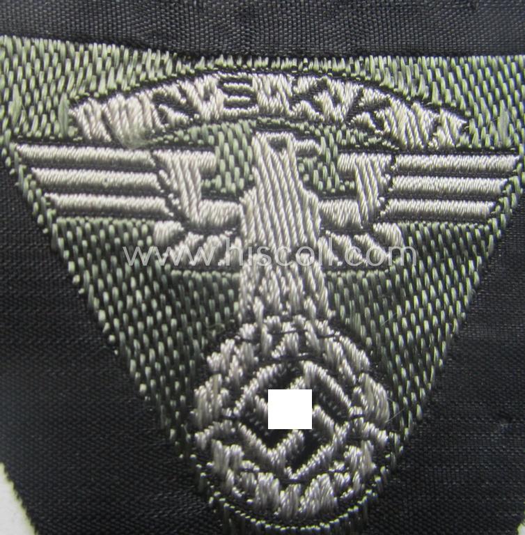 N.S.K.K. (ie. 'National Socialistisches Kraftfahr Korps') side-cap-eagle (ie. 'Adler für N.S.K.K.-Schiffchen o. Lagermütze') being a 'BeVo'-woven-example onto a bright-grey-coloured background