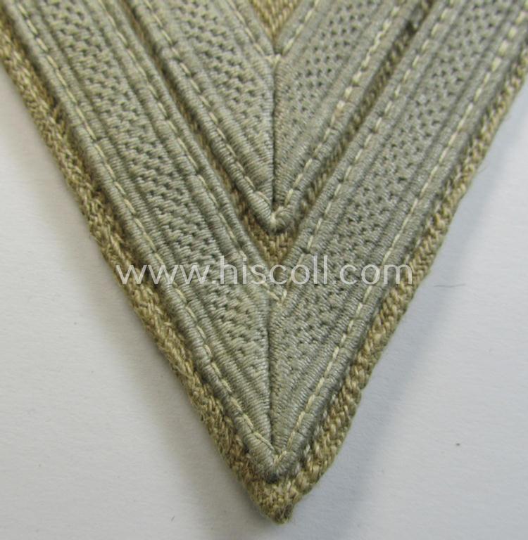 Neat, WH (Luftwaffe) 'Armwinkel' (or: arm-chevron) as was executed on a beige-white-coloured- and/or 'HBT'-like (ie. 'Drillich'-) based background as was specifically intended for usage by an: 'Obergefreiter'