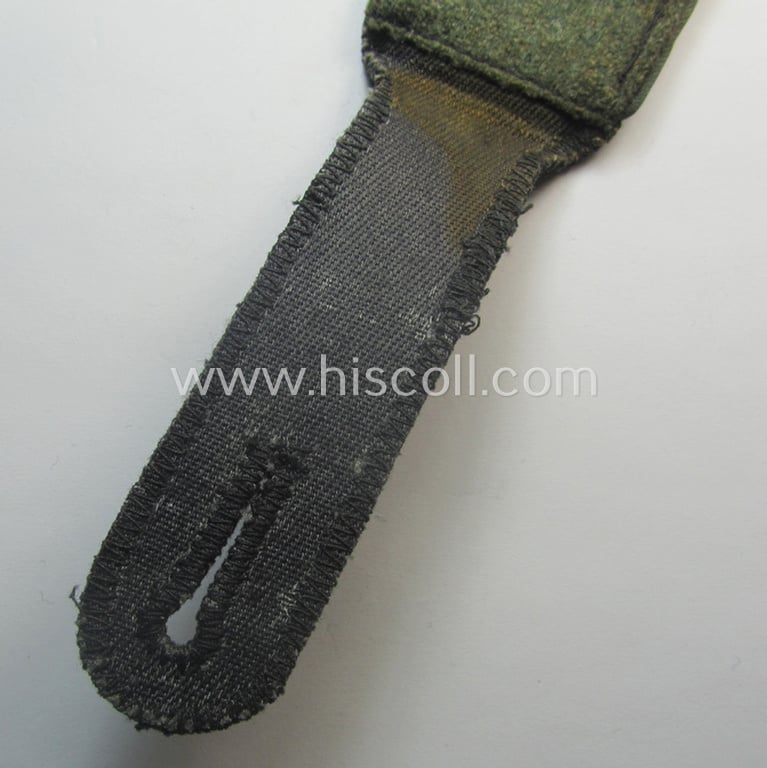 Attractive - albeit regrettably single! - Waffen-SS, EM-type shoulderstrap as piped in the bright-blue-coloured branchcolour as was intended for usage by an: 'SS-Mann' who served within the: 'SS-Nachschub-Trpn.'