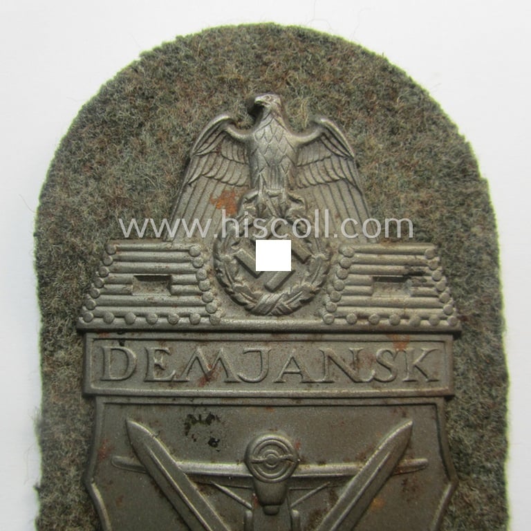 Superb - and fairly scarcely encountered! - example of a WH (Heeres ie. Waffen-SS) 'Demjansk'-campaign-shield as executed in typical magnetic metal (ie. so-called: 'Eisenblech') and that comes in an overall very nice- ie. fully untouched, condition