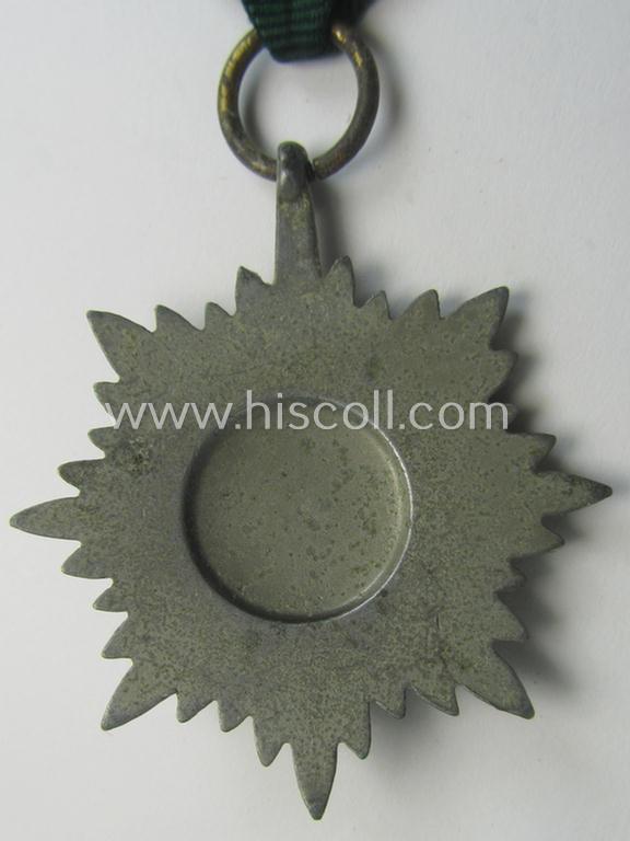 WH-related so-called: 'Verdienstauszeichnung für Angehörige der Ostvölker, 2. Klasse in Silber ohne Schwerter', being a typical non-maker-marked- and/or: 'Feinzink'-based example that comes mounted on its period ribbon