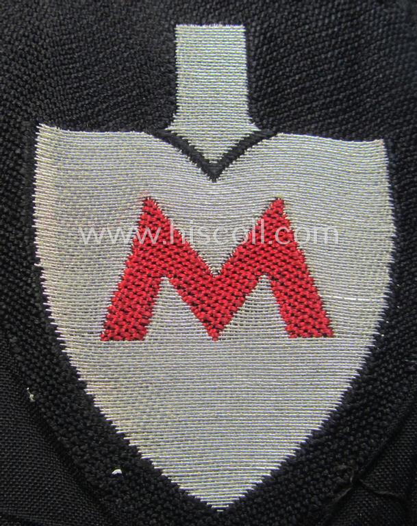 Attractive - and actually very scarcely encountered! - officers'-pattern, so-called: RAD (ie. 'Reichsarbeitsdienst') sleeve-badge (or: 'Dienststellenabzeichen') bearing the specialist-designation: 'M' (or: 'Hauptmeldebeambter')
