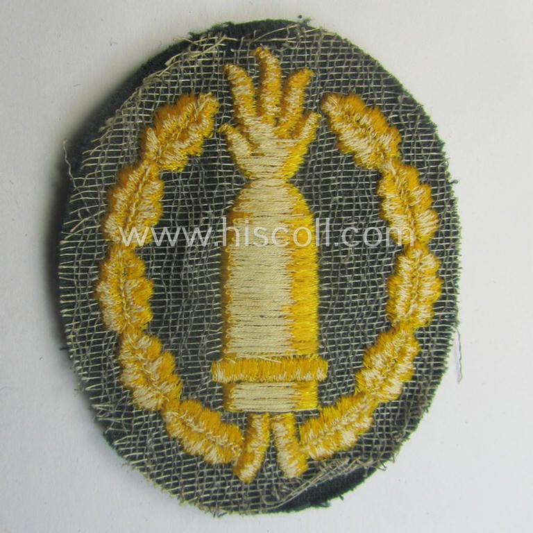Machine-embroidered, WH (Heeres) so-called: 'Richtabzeichen für Artillerie-Richtkannoniere' (or: artillery gun-layers patch) being a detailed example that comes in a never used- ie. 'virtually mint-/unissued'-, condition
