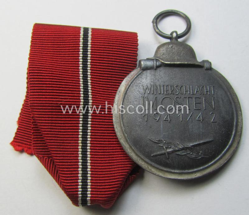 Attractive medal-set: 'Winterschlacht im Osten 1941-42' being a maker- (ie. '14'-) marked- (and/or 'Feinzink'-based) specimen by the maker: 'L.Chr. Lauer' and that comes together with its (minimally confectioned) ribbon (ie. 'Bandabschnitt'...