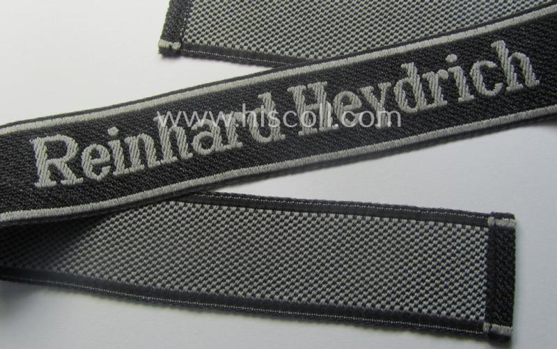 Waffen-SS, 1943-pattern cuff-title (ie. 'Ärmelstreifen') depicting the machine-woven Latin script text in silver-grey linnen as was intended for a member of the: 'SS-Geb.Jäg.-Rgts. 6. (u.11.)': "Reinhard Heydrich"