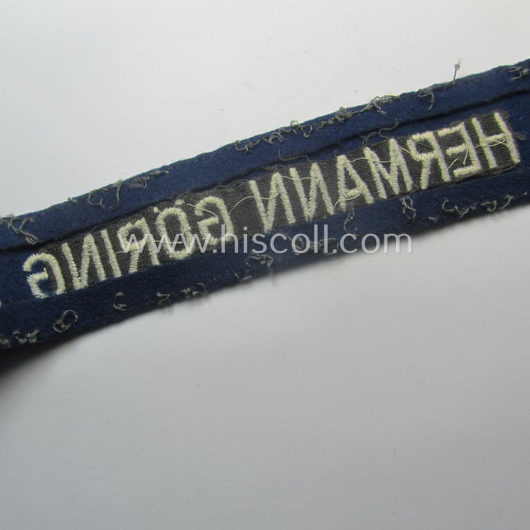 Truly used and typical 'smooth-woolen'-based, EM- (ie. NCO-) pattern WH (Luftwaffe) cuff-title (ie. 'Ärmelstreifen') entitled: 'Hermann Göring' that comes in a period-shortened and worn condition