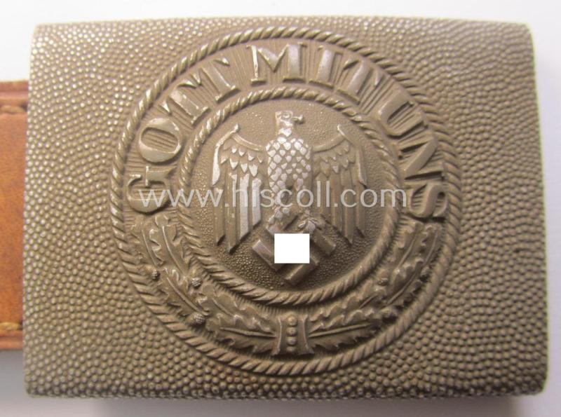 WH (Heeres) 'standard-pattern', field-grey-toned- and aluminium-based belt-buckle being a maker- (ie. 'Hermann Knoller - Pforzheim'-) marked- and/or: '1939'-dated example that comes mounted onto its leather-based tab