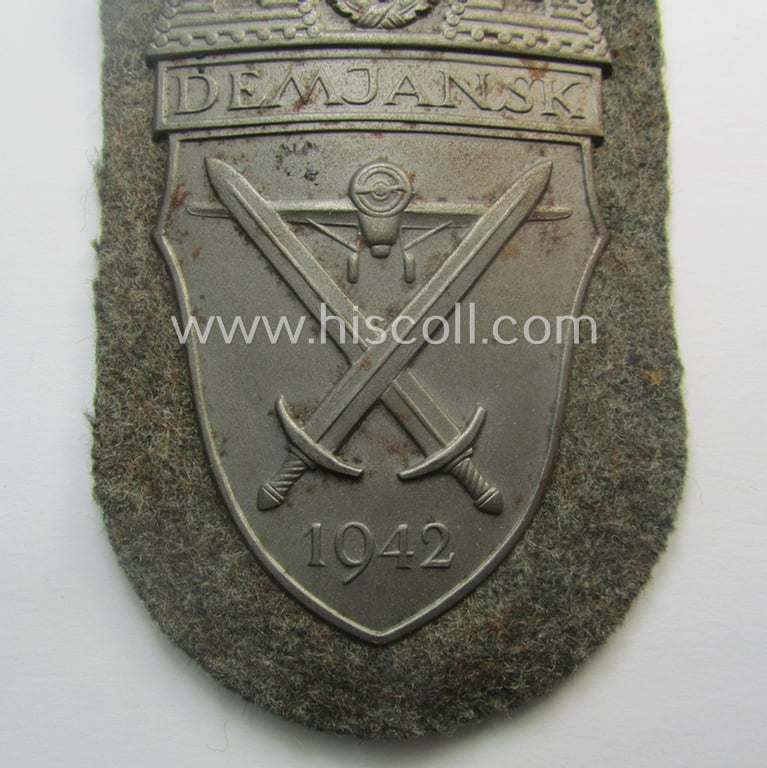 Superb - and fairly scarcely encountered! - example of a WH (Heeres ie. Waffen-SS) 'Demjansk'-campaign-shield as executed in typical magnetic metal (ie. so-called: 'Eisenblech') and that comes in an overall very nice- ie. fully untouched, condition
