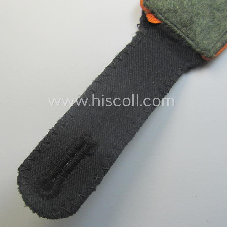 Single, Waffen-SS, EM-type shoulderstrap as piped in the bright-orange-coloured branchcolour as was intended for usage by an: 'SS-Mann' who served within the: 'SS-Feldgendarmerie-Trpn.'