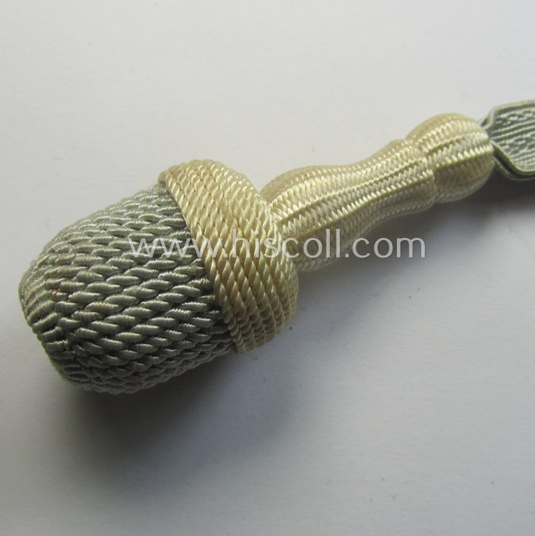 Smaller-sized (ie. miniature) so-called: 'watch-fob' (ie. key-holder) as executed in the form of a greyish-/white-coloured NCO-type side-arm knot (ie. 'Portepee' or: 'Troddel') as was used for the various WH-type bayonets