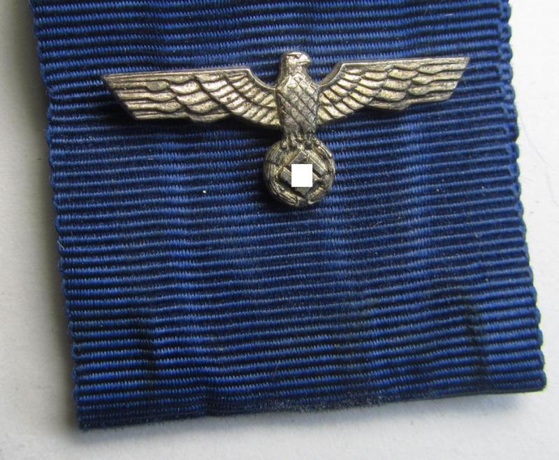 Bright-silver-toned WH (Heeres o. KM): 'WH-Dienstauszeichnung der 2. Stufe' (as was intended for 18 years of loyal-service) that comes together with its period ribbon (ie. 'Bandabschnitt') having a detailed eagle-device period-attached
