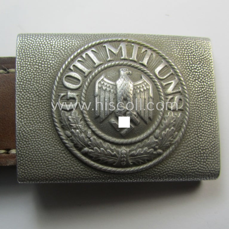 Moderately used WH (Heeres) 'standard-pattern', silver-toned- and aluminium-based belt-buckle being a maker- (ie. 'St.Merkl - Nürnberg'-) marked- and/or: '1938'-dated example that comes mounted onto its leather-based tab