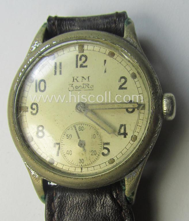 WH (Kriegsmarine) WWII-period wrist-watch (or: 'Dienstuhr') of the make: 'K.M. - Zentra' having a beige-white-coloured dial-plate and neatly engraved number on its back that reads: '528261'