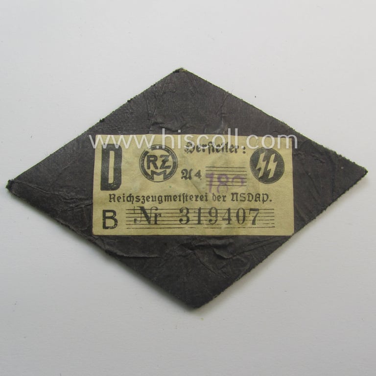 Superb, 'SS'-related sleeve-diamond (ie.: 'Ärmelraute für Führer im Gerichtsdienst') being a very detailed- and hand-embroidered example that still retains its period, paper-based: 'RzM'-etiket