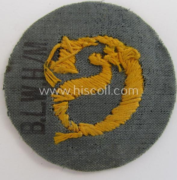 WH (Heeres) so-called: trade- and/or special-career arm-insignia (ie. 'Laufbahn- o. Tätigkeitsabzeichen') as intended for a: 'Schirrmeister' (being a neatly hand-embroidered variant as mounted onto a darker-green woolen background)